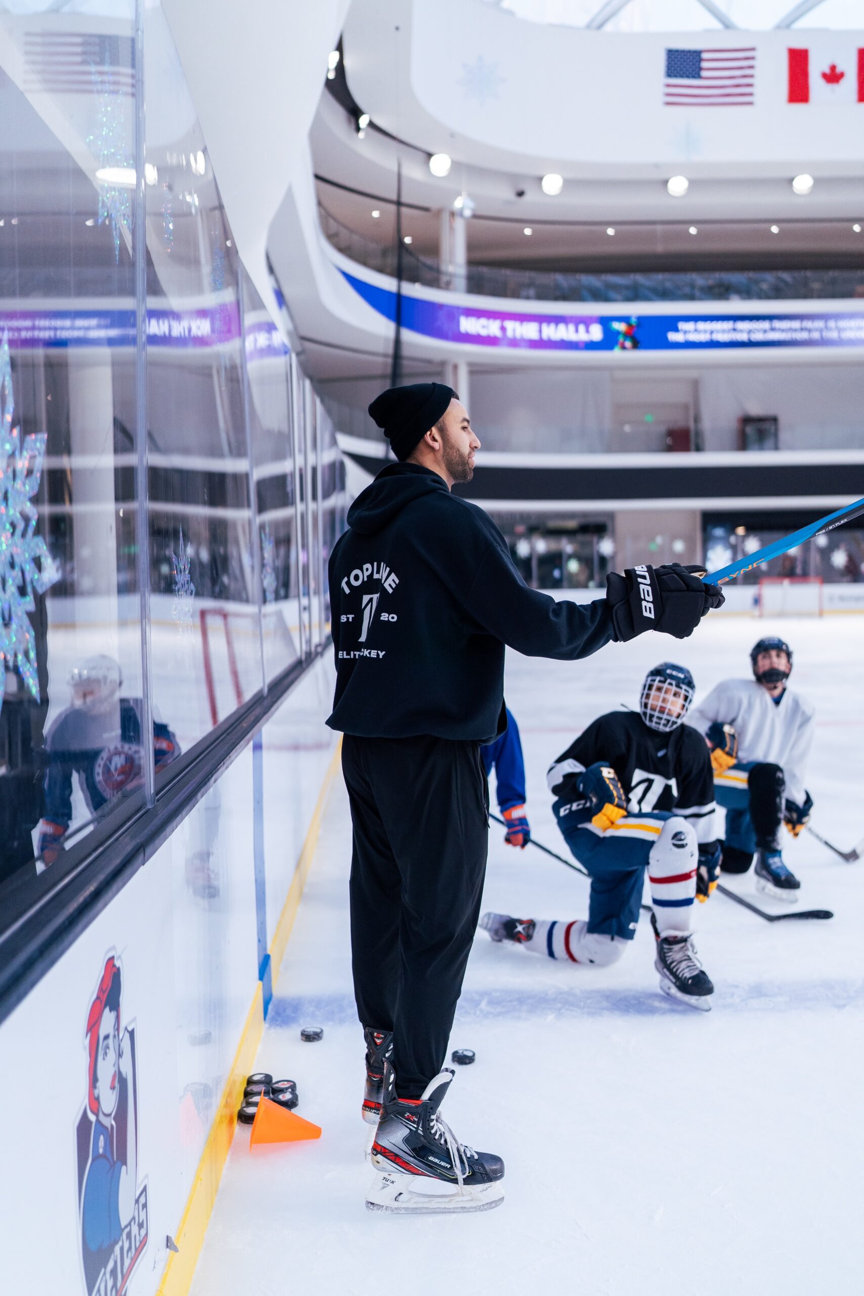 A hockey coach teaching players a drill